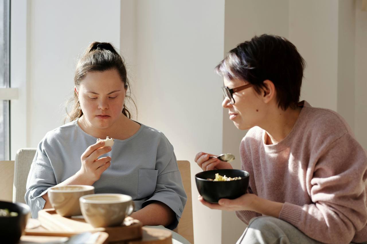 Support worker sharing a meal with a participant